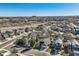 Aerial view of a red home surrounded by residential neighborhood and green spaces at 9408 High Cliffe St, Highlands Ranch, CO 80129