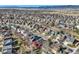 A high angle aerial view of a neighborhood showing many similar homes, yards, and distant mountains at 9408 High Cliffe St, Highlands Ranch, CO 80129