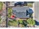 Aerial view of a well-maintained home showcasing a backyard patio with red umbrella and surrounding landscaping at 9408 High Cliffe St, Highlands Ranch, CO 80129