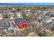 An aerial view of a red home in a neighborhood, showing its roof, yard, and surrounding houses on a sunny day at 9408 High Cliffe St, Highlands Ranch, CO 80129