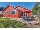 A backyard patio with a dining set and red umbrella offers an outdoor entertaining space at 9408 High Cliffe St, Highlands Ranch, CO 80129