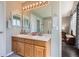 Bathroom featuring double sinks and a large mirror with Hollywood style lighting at 9408 High Cliffe St, Highlands Ranch, CO 80129