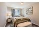 The bedroom features a neutral wall color with a gold bed frame, light colored linens, and a picture of birds at 9408 High Cliffe St, Highlands Ranch, CO 80129