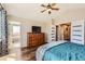 Main bedroom with hardwood floors and a ceiling fan includes an ensuite bathroom and walk in closet at 9408 High Cliffe St, Highlands Ranch, CO 80129