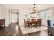 View of dining room showcasing hardwood floors, dining table, and view to the entry and an opening to the kitchen at 9408 High Cliffe St, Highlands Ranch, CO 80129