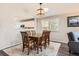 The dining room shows a wood table, six chairs, area rug and natural light from a window at 9408 High Cliffe St, Highlands Ranch, CO 80129