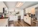 Bright kitchen featuring white cabinets, stainless steel appliances, and an open layout to the living area at 9408 High Cliffe St, Highlands Ranch, CO 80129