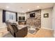 Inviting basement living room with stone accent wall, comfortable seating, and ample lighting at 9408 High Cliffe St, Highlands Ranch, CO 80129
