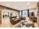 Cozy basement living room with stone accent wall, comfortable seating, and hardwood floors at 9408 High Cliffe St, Highlands Ranch, CO 80129