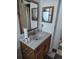 Bathroom sink and vanity, including a mirror, with black and white floors at 15003 Olmsted Dr, Denver, CO 80239