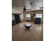 Bright living room with tile flooring, built-in shelving, and a comfortable seating area at 15003 Olmsted Dr, Denver, CO 80239