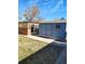 View of backyard outbuildings with ample lawn space and natural light, perfect for outdoor projects at 15003 Olmsted Dr, Denver, CO 80239