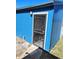 Exterior view of a blue shed with a secure door, ideal for storage or a workshop at 15003 Olmsted Dr, Denver, CO 80239