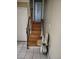 Stairway with a chair lift, wood steps and tile flooring at 15003 Olmsted Dr, Denver, CO 80239