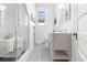 Bright bathroom with glass shower, white vanity, and black and white tiled floor at 1723 E 16Th Ave, Denver, CO 80218