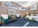 Comfortable bedroom with brick walls, two green chairs, and soft blue carpet at 1723 E 16Th Ave, Denver, CO 80218