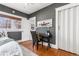 Clean, stylish bedroom with hardwood flooring, desk, and white closet at 1723 E 16Th Ave, Denver, CO 80218