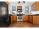 Traditional kitchen boasts wooden cabinets, stainless steel appliances, and black countertops at 1723 E 16Th Ave, Denver, CO 80218