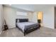 Comfortable bedroom featuring neutral carpeting and an en suite bathroom with a walk in closet at 6492 N Ceylon St, Denver, CO 80249