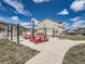 Community grill area with string lights and red picnic tables at 6492 N Ceylon St, Denver, CO 80249