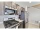 Modern kitchen featuring stainless steel appliances, dark cabinets, and light countertops at 6492 N Ceylon St, Denver, CO 80249