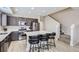 Modern kitchen featuring white countertops, dark cabinetry, and stainless steel appliances and a carpeted staircase at 6492 N Ceylon St, Denver, CO 80249