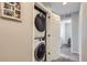 Efficient laundry closet with stacked washer and dryer in a hallway setting at 6492 N Ceylon St, Denver, CO 80249