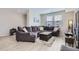 Comfortable living room featuring a large sectional sofa, neutral tones and light wood laminate flooring at 6492 N Ceylon St, Denver, CO 80249