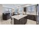 Open concept living room and kitchen area with hardwood-style floors and neutral paint at 6492 N Ceylon St, Denver, CO 80249