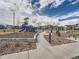 Community playground features climbing structure with a slide and play area at 6492 N Ceylon St, Denver, CO 80249