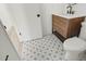 Charming bathroom features decorative floor tile, a wood vanity with black fixtures, and white walls at 6539 Pinewood Dr # 57, Parker, CO 80134