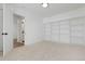 Neutral bedroom features an open shelving unit and neutral carpet at 6539 Pinewood Dr # 57, Parker, CO 80134