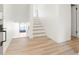 Home foyer featuring staircase and modern wood-look floors at 6539 Pinewood Dr # 57, Parker, CO 80134