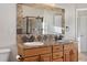 Bathroom featuring double sinks, a large framed mirror, and decorative tile accents at 15455 Canyon Rim Dr # 307, Englewood, CO 80112