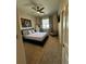 Comfortable bedroom featuring a queen-sized bed, neutral colors, and a cozy seating area at 15455 Canyon Rim Dr # 307, Englewood, CO 80112