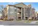 Inviting three-story condo building with stone accents, balconies, and well-maintained landscaping at 15455 Canyon Rim Dr # 307, Englewood, CO 80112