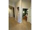 Hallway with a glimpse into a bathroom and an alcove, showcasing the home's layout at 15455 Canyon Rim Dr # 307, Englewood, CO 80112