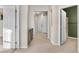 Inviting hallway with tile flooring leads to various rooms, showcasing the home's layout and flow at 15455 Canyon Rim Dr # 307, Englewood, CO 80112