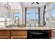 Stylish kitchen island featuring granite countertops and modern fixtures and appliances at 15455 Canyon Rim Dr # 307, Englewood, CO 80112