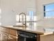 Kitchen island with stone counters and stainless steel faucet at 15455 Canyon Rim Dr # 307, Englewood, CO 80112