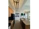 Open-concept kitchen with island, modern lighting, and stainless steel appliances at 15455 Canyon Rim Dr # 307, Englewood, CO 80112