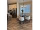Cozy dining area with modern lighting fixture, matching chairs, and wood-look flooring at 13432 Broad Wing Dr, Parker, CO 80134