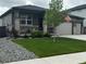 Well-maintained single-story home with a lush lawn, covered porch, and a two-car garage at 13432 Broad Wing Dr, Parker, CO 80134