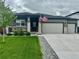 Charming single-story home featuring a covered porch, two-car garage, and well-manicured lawn at 13432 Broad Wing Dr, Parker, CO 80134
