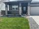 Beautifully landscaped front yard with lush green grass and stone accents on the home's facade at 13432 Broad Wing Dr, Parker, CO 80134