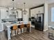 Modern kitchen featuring white cabinets, stainless steel appliances, and a stylish center island with seating at 13432 Broad Wing Dr, Parker, CO 80134