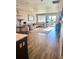Bright living room with hardwood floors, a comfortable sectional sofa, and sliding doors leading to a balcony at 13432 Broad Wing Dr, Parker, CO 80134