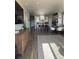Open-concept living room flows into a modern kitchen, featuring hardwood floors and stylish furnishings at 13432 Broad Wing Dr, Parker, CO 80134