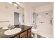 Bright bathroom features a granite countertop, large mirror, and tiled walk-in shower at 2985 Blue Sky Cir # 7-107, Erie, CO 80516