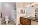 Cozy bathroom with updated granite countertop, wood cabinetry, and a shower-tub combo at 2985 Blue Sky Cir # 7-107, Erie, CO 80516